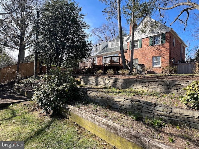 view of yard with a deck and fence