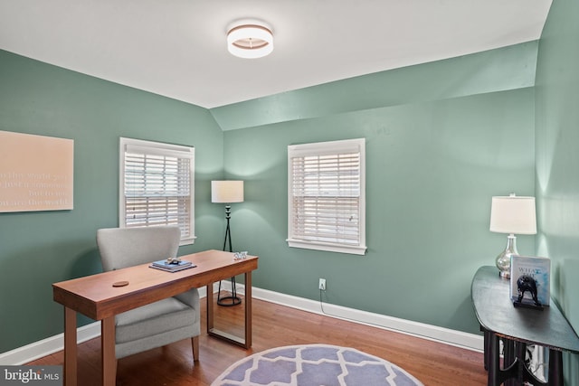 office space with baseboards, lofted ceiling, and wood finished floors