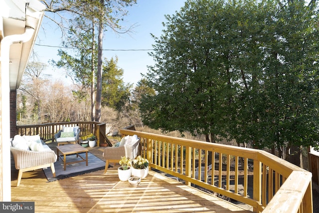 wooden terrace with an outdoor hangout area