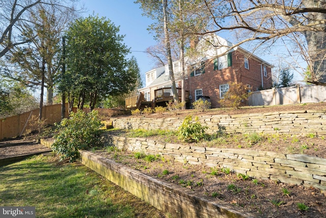 view of yard with a wooden deck and fence