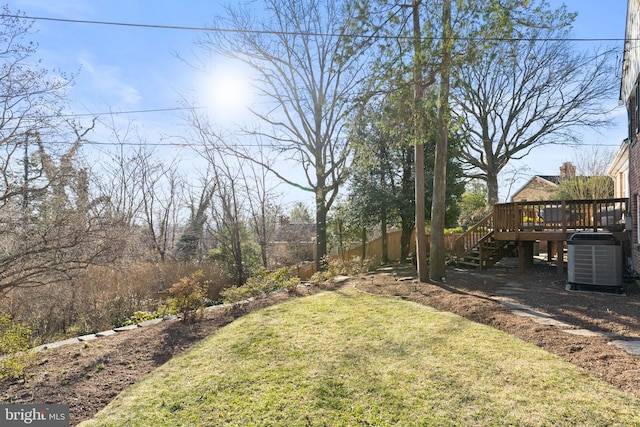 view of yard with a wooden deck, central AC, stairs, and fence