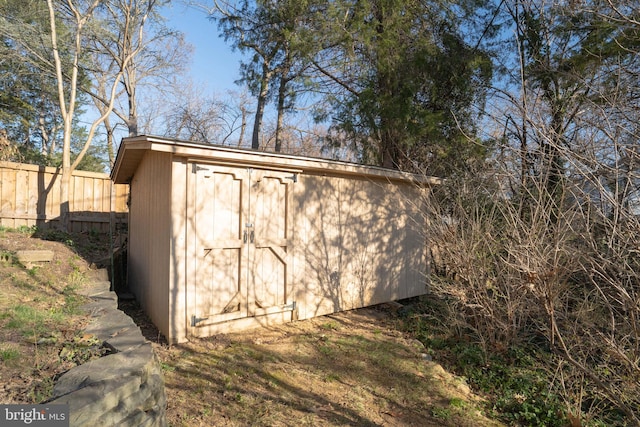 view of shed with fence