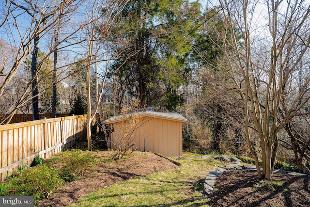 view of yard with a shed, an outdoor structure, and fence