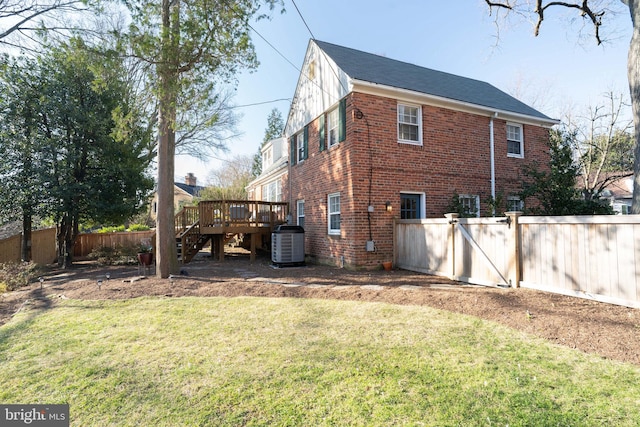 view of side of property with brick siding, fence, stairway, cooling unit, and a deck