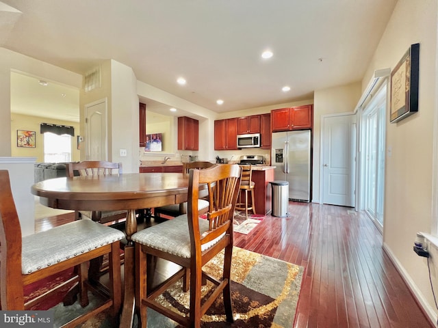 dining room with recessed lighting, baseboards, and hardwood / wood-style flooring