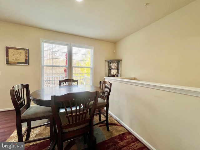 dining area featuring baseboards and wood finished floors