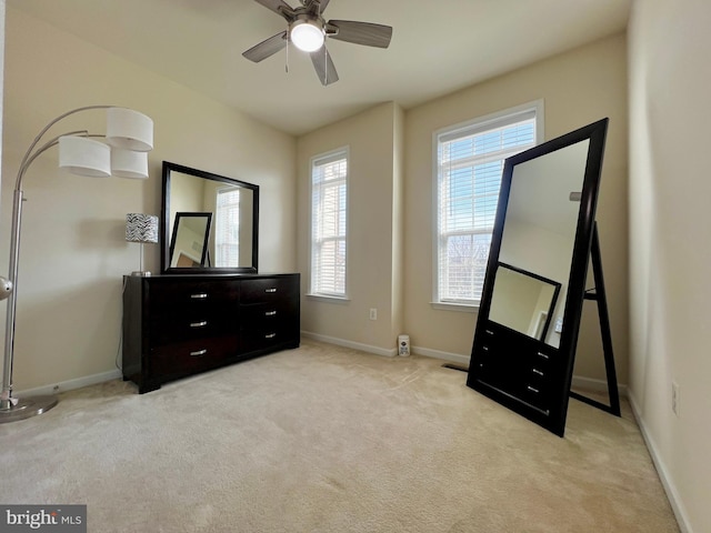 carpeted bedroom featuring a ceiling fan and baseboards