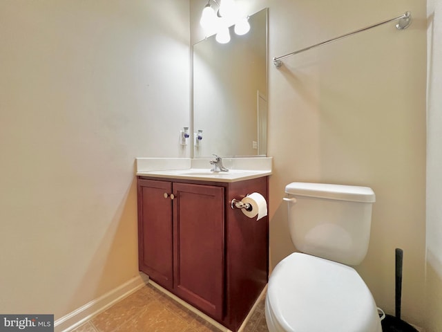 bathroom featuring tile patterned floors, toilet, vanity, and baseboards