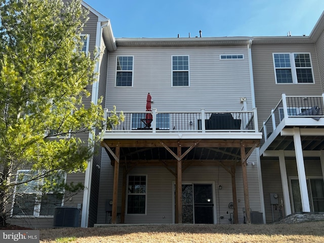 back of house featuring central AC unit and a deck