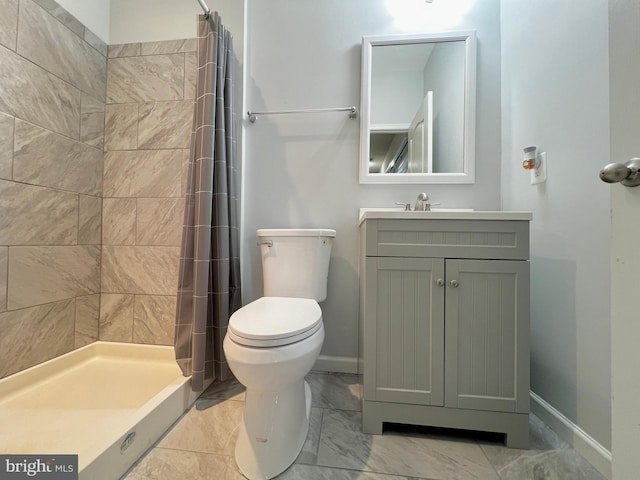 bathroom with baseboards, toilet, tiled shower, marble finish floor, and vanity