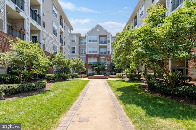 view of home's community featuring a lawn