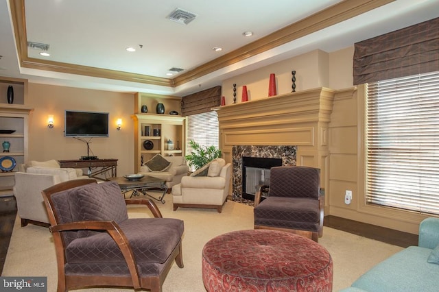 living room with visible vents, a fireplace, and a raised ceiling