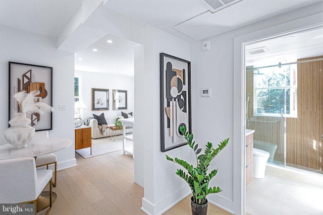 corridor featuring recessed lighting, visible vents, wood-type flooring, and baseboards