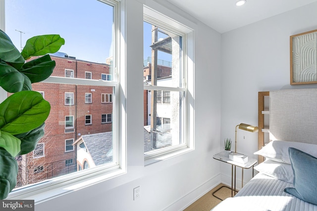 living area featuring recessed lighting and baseboards