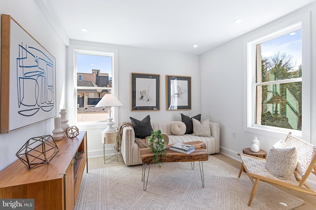 living room with recessed lighting, baseboards, and a healthy amount of sunlight