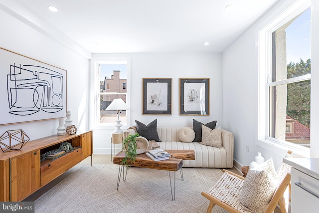 living area featuring recessed lighting and baseboards