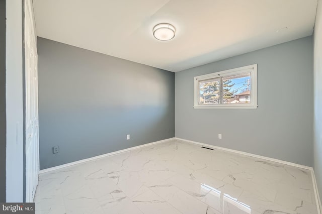 unfurnished room featuring visible vents, baseboards, and marble finish floor