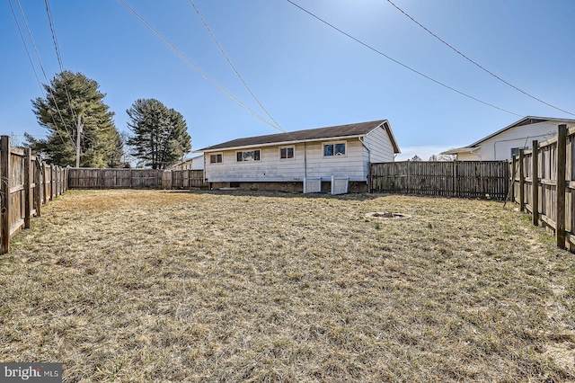 back of house featuring a fenced backyard