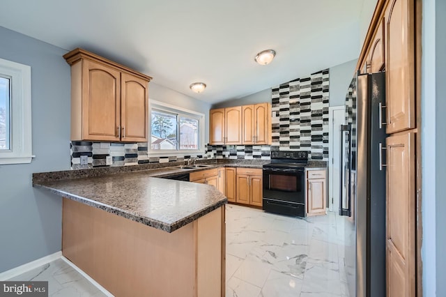 kitchen with black / electric stove, a peninsula, a sink, dark countertops, and marble finish floor