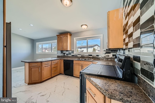 kitchen featuring dark countertops, marble finish floor, black appliances, and a sink