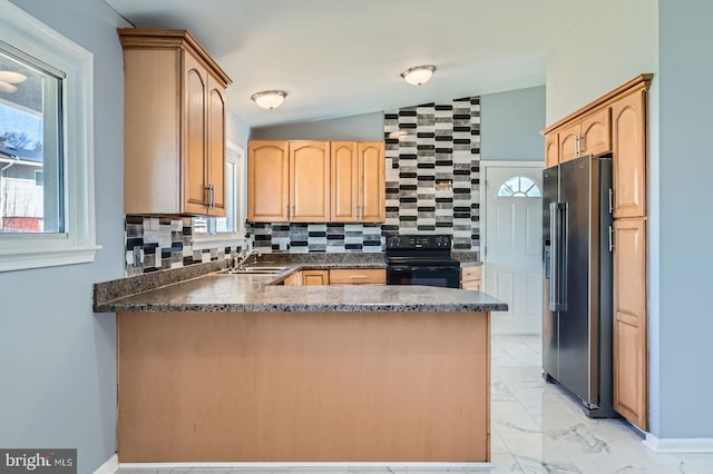 kitchen featuring marble finish floor, a sink, black range with electric cooktop, a peninsula, and high end refrigerator