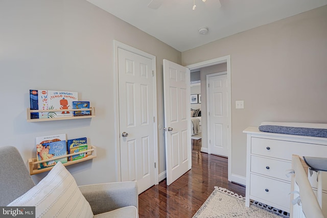 interior space featuring wood finished floors, baseboards, and ceiling fan