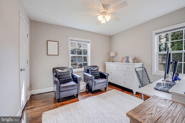 interior space featuring baseboards, dark wood-style floors, and a ceiling fan