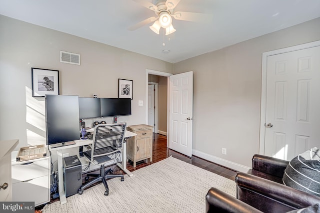 office space with visible vents, baseboards, wood finished floors, and a ceiling fan