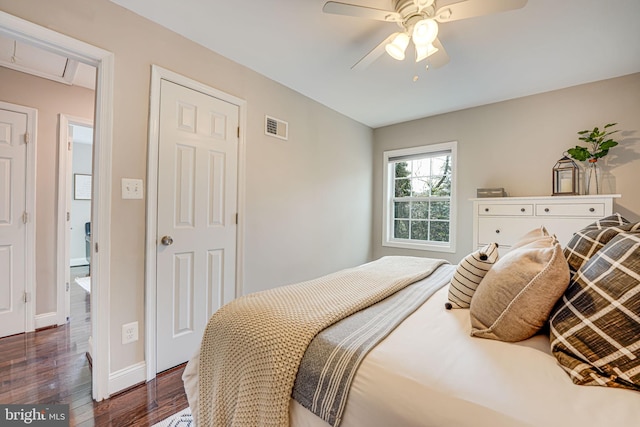 bedroom featuring dark wood-type flooring, baseboards, visible vents, and ceiling fan