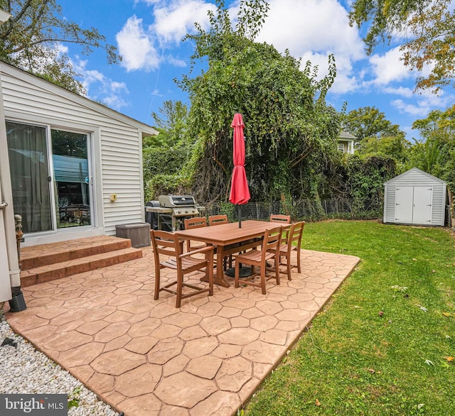 view of patio featuring outdoor dining space, fence, a shed, grilling area, and an outdoor structure