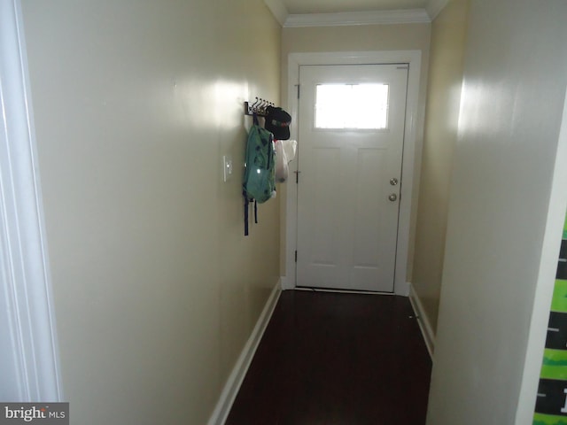 entryway with crown molding, dark wood-style floors, and baseboards