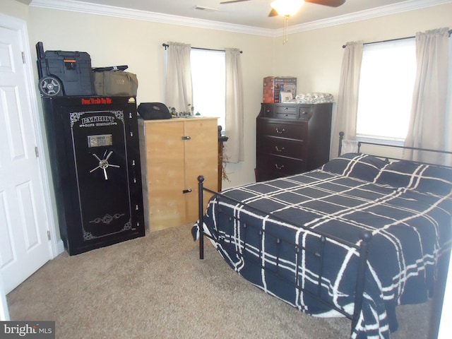 carpeted bedroom with multiple windows, a ceiling fan, and ornamental molding