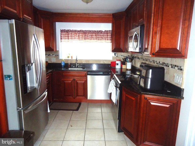 kitchen featuring a sink, stainless steel appliances, and dark brown cabinets