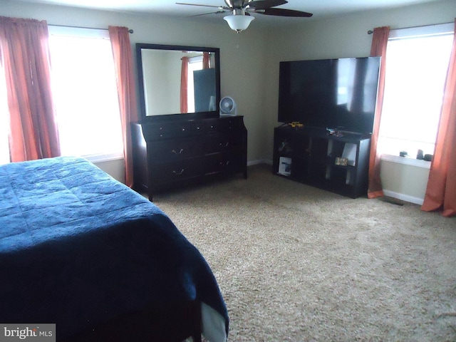 bedroom with multiple windows and ceiling fan