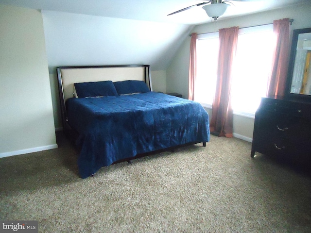 bedroom featuring baseboards, lofted ceiling, and carpet floors