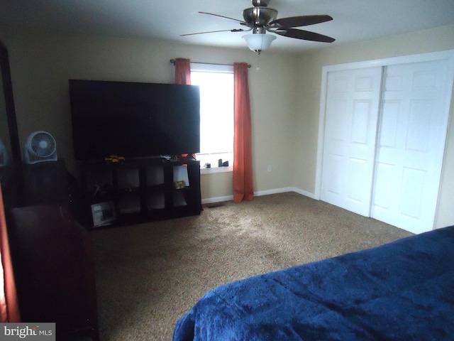 bedroom with a ceiling fan, baseboards, and carpet floors