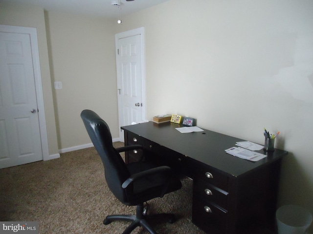 carpeted office featuring baseboards