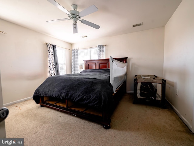 bedroom with visible vents, carpet flooring, baseboards, and a ceiling fan