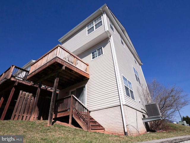 back of house featuring stairway and a deck