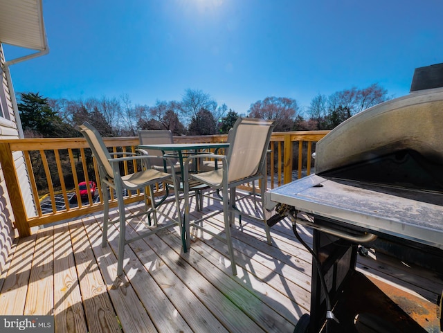 wooden terrace featuring outdoor dining area