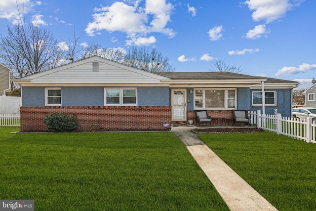 view of front of house with a front lawn, fence, and brick siding