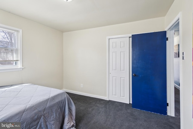 bedroom featuring baseboards, a closet, and carpet floors