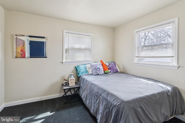 bedroom with baseboards and carpet floors