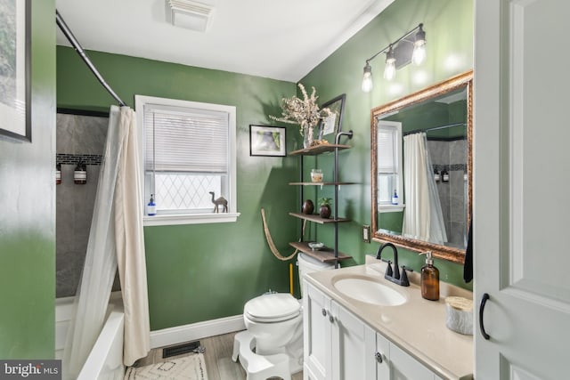 full bath with toilet, wood finished floors, shower / bath combination with curtain, baseboards, and vanity