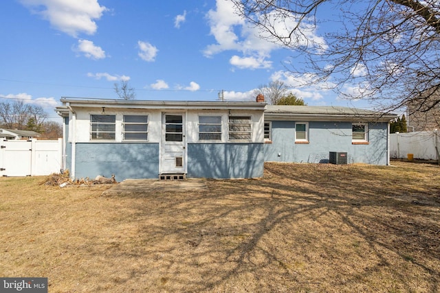 back of property with central air condition unit, stucco siding, and fence