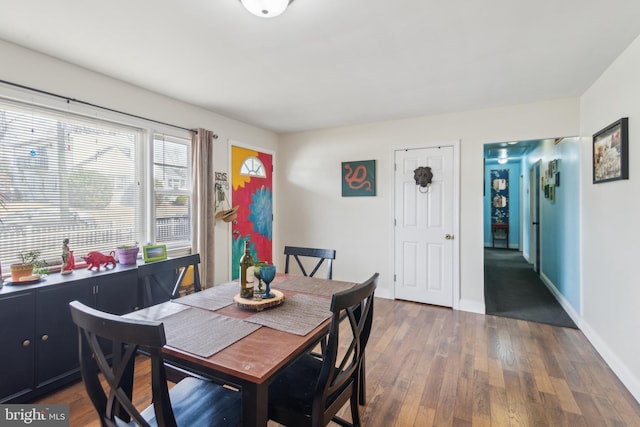 dining area featuring wood finished floors and baseboards