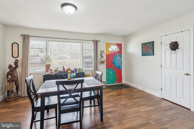 dining space with wood finished floors, baseboards, and a healthy amount of sunlight