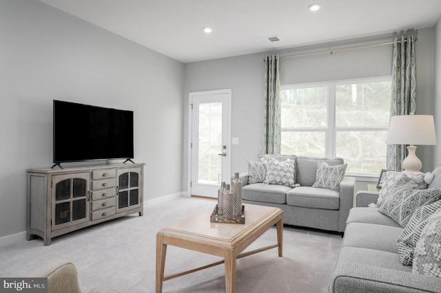 living area with light carpet, visible vents, recessed lighting, and baseboards