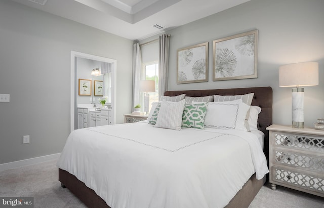 bedroom featuring visible vents, baseboards, ensuite bathroom, and carpet