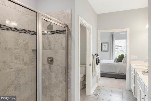 bathroom with toilet, a stall shower, connected bathroom, tile patterned flooring, and vanity